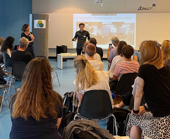 Viele Personen sitzen in einem Workshop